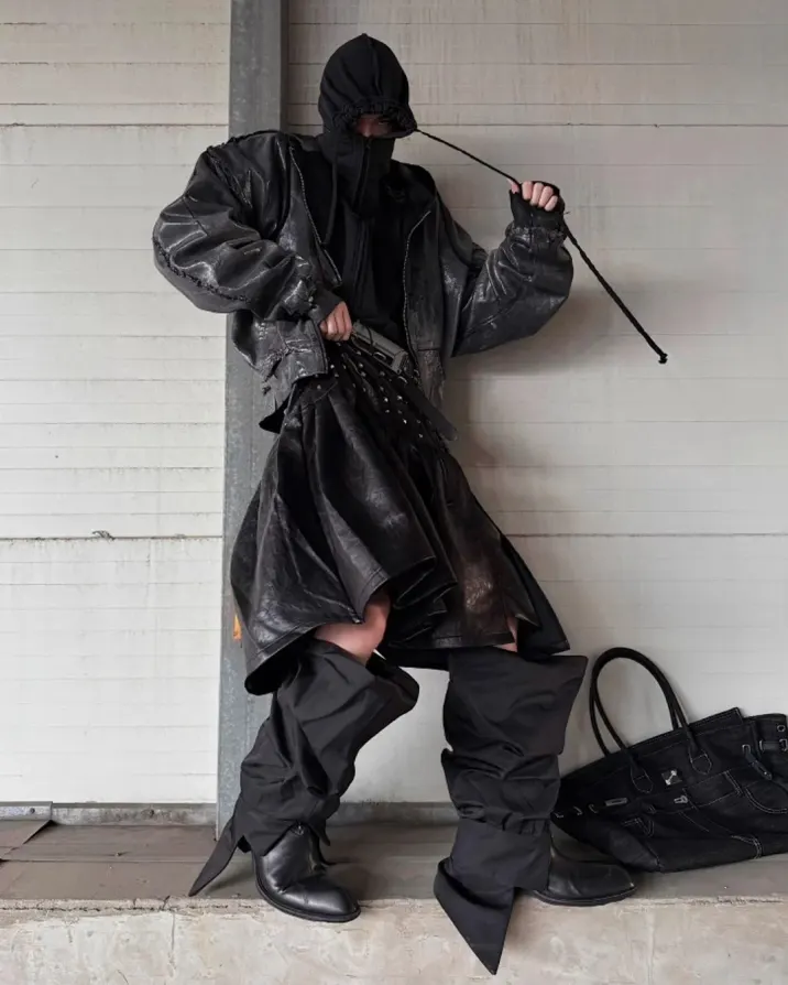 Steel in the spine. Shadows in the fold. Walk like you own the wasteland. Shop now at psylos1.com GOJOYJINNI | Rivet Pleat Leather Skirt #villainarc #techwear #darkfashion #runway (2/3)